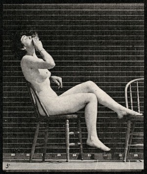view A woman sitting naked on a chair and smoking. Collotype