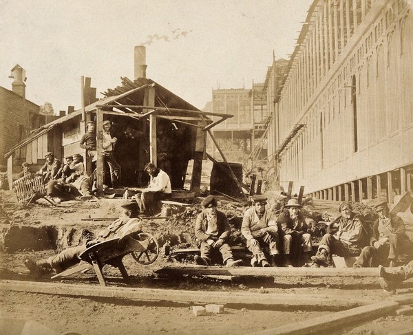 The Crystal Palace during its re-erection at Sydenham, London: construction workers taking a break on site. Photograph by Philip Delamotte, ca. 1854.