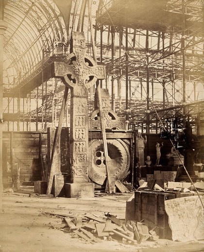 The Crystal Palace during its re-erection at Sydenham, London: a large celtic cross and other statues in the unfinished interior. Photograph by Philip Delamotte, ca. 1854.