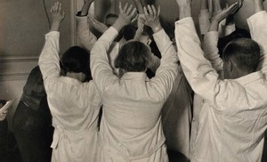 view Spiritualist healing amongst W. T. Parish's congregation: his assistants raise their hands as the patient is healed. Photograph by Kurt Lubinski, ca. 1940.