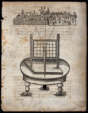 A circular table upon which a perspective grid has been placed for viewing a town with a river. Engraving.