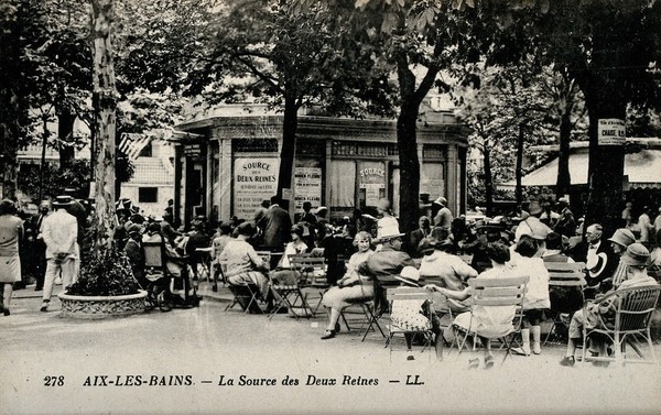 Aix-les-Bains, France: people sitting oudoors near the Source des Deux Reines. Photographic postcard, ca. 1920.