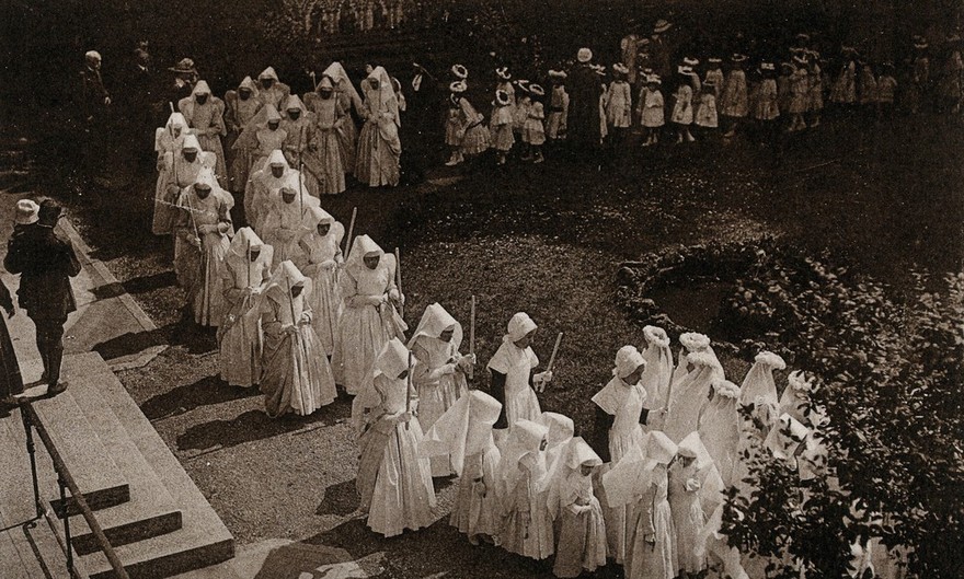 Beaunes, France: a religious procession of nurses and children at the Hôtel Dieu. Photographic postcard, ca. 1930.