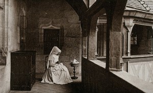 view Beaunes, France: a nurse sewing in the first floor gallery of the Hôtel Dieu. Photographic postcard, ca. 1930.