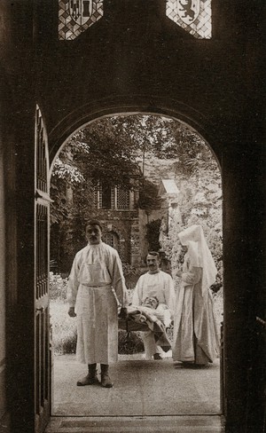 view Beaunes, France: the arrival of a wounded at the Hôtel Dieu. Photographic postcard, ca. 1930.