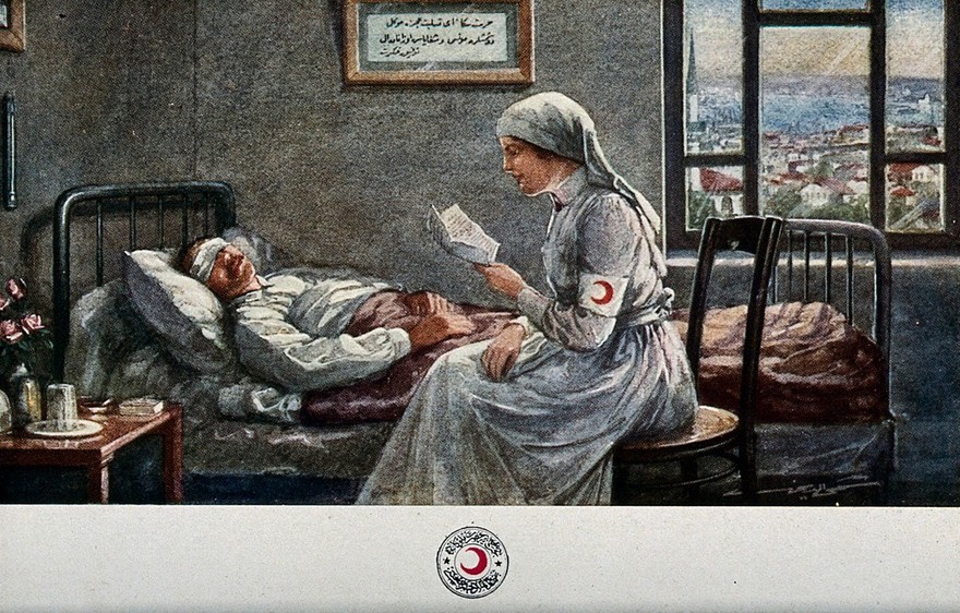 A Red Crescent nurse is sitting at the bedside of a wounded soldier with a bandage over his eyes; she is reading him a letter. Colour process print.