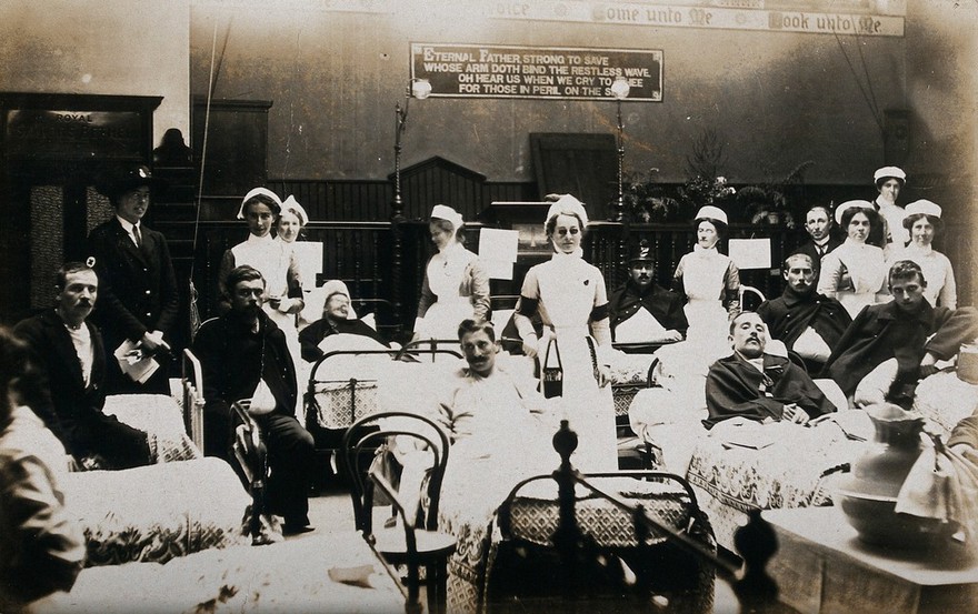 Nurses and patients in a naval hospital ward. Photographic postcard, ca. 1915.
