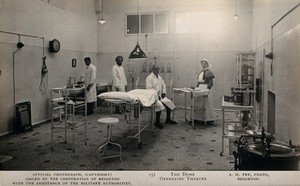 view Two Indian doctors with a British doctor and a British nurse in the operating theatre of the Royal Pavilion, Brighton. Photographic postcard by A.H. Fry, ca. 1915.