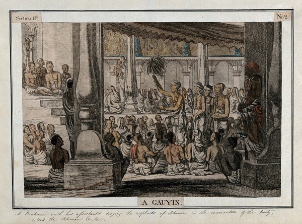 Hindu priest, or brahmin, and assistants, singing to a seated audience, Calcutta, West Bengal. Coloured etching by François Balthazar Solvyns, 1799.