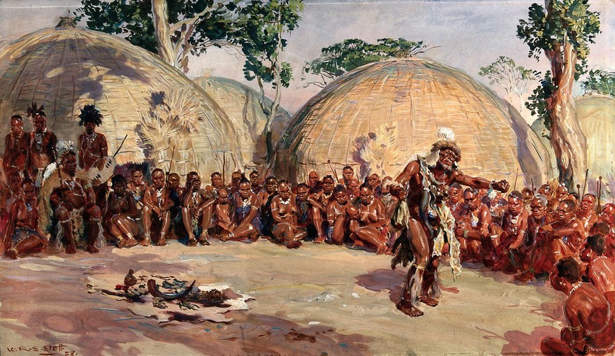 A Zulu medicine man dancing in order to detect which one of the women seated around them has bewitched their ruler. Gouache by W.R.S. Stott, 1928.