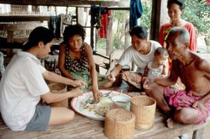 view Family sharing a meal in Thailand