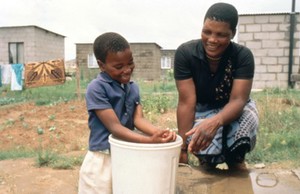 view Sanitation: mother supervising child washing hands