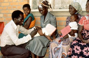 view Child receiving vaccine at fixed site facility Zambia