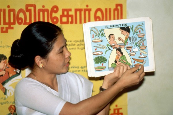 Health worker giving nutrition education, India