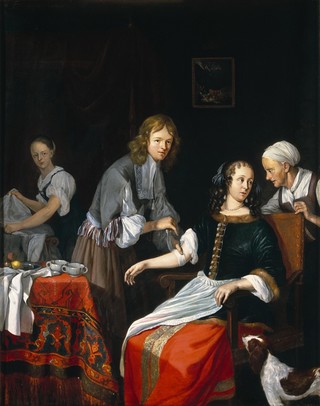 A surgeon binding up a woman's arm after bloodletting. Oil painting by Jacob Toorenvliet, 1666.