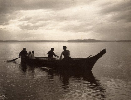 Salish people in a canoe on Puget Sound, North America. Photograph by Edward S. Curtis, ca. 1900.