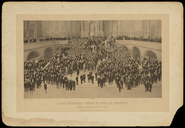 Seventh International Congress of Hygiene and Demography, London: participants standing on a monumental staircase with a statue of Queen Victoria in a niche at the top. Photograph by Barrauds, 1891.