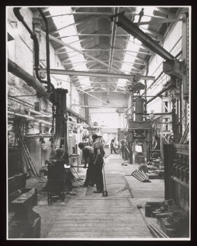 Smith's shop, Davy & United Engineering Co. Ltd., Park Iron Works, Sheffield: men are shown operating hydraulic presses, steam and pneumatic power hammers and gas fired furnaces. Photograph, 1957.