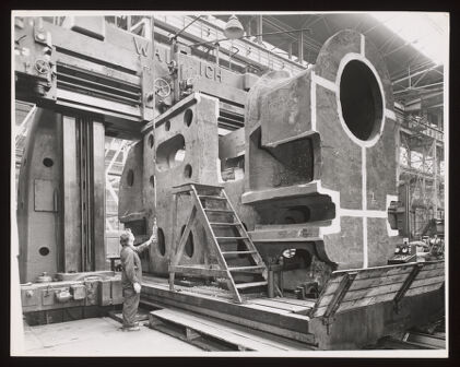 Single piece of steel casting being machined on a large heavy planer, Davy & United Engineering Co. Ltd., Park Iron Works, Sheffield: a man is shown operating heavy machinery. Photograph, 1957.