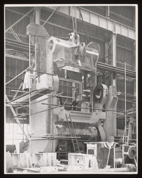 Heavy erecting work for rolling mill engraving, Davy & United Engineering Co. Ltd., Park Iron Works, Sheffield: men are shown operating heavy machinery. Photograph, 1957.