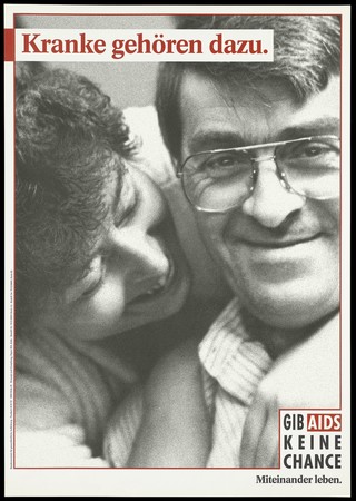 A smiling woman bends down to communicate with a man with chronic illness; representing the need to protect the chronically sick against AIDS. Colour lithograph, 199-.