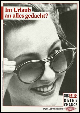 A woman with painted lips peering over her sunglasses; representing the risk of contracting AIDS while on holiday. Colour lithograph, 199-.