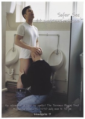 Two men perform oral sex beside some latrines; an advert for safe sex by the Terrence Higgins Trust. Colour lithograph.