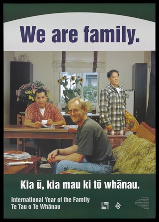 A man sitting at a table with a cup and saucer, another holding a skateboard, and another sitting on a sofa representing a gay family; advertisement for International Year of the Family by the Human Rights Commission in 1994. Colour lithograph by Matthew McKee.