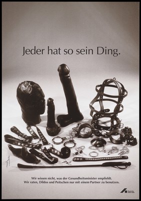 Sadomasochism leather gear including a mask, a dildo, handcuffs, nipple piercing chains, a collar and a whip; advertising safe sex. Colour lithograph by J. Mang and Trash Line Design for the Deutsche AIDS-Hilfe e.V.