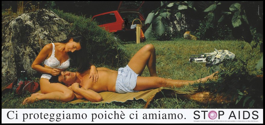 A woman in white underwear strokes the hair of a man lying down wearing boxer shorts with a portable radio, their car and a fox in the undergrowth nearby; two packs of red condoms lie in a bag to the left; an Italian version of a series of Stop AIDS campaign posters by the Federal Office of Public Health, in collaboration with Aiuto AIDS Svizzero. Colour lithograph.