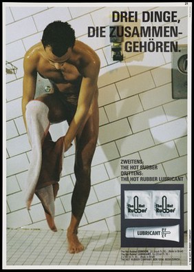 A naked man drying himself with a towel in a public shower with two packets of condoms and a tube of lubricant bearing the logo of The Hot Rubber Company; a safe sex advertisement for condoms produced by The Hot Rubber Company (Zürich). Colour lithograph.