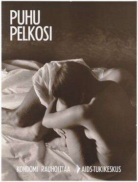 A woman hugging her knees next to her partner who lies down beside her wrapped in a sheet with the message 'talk about fear; condoms reassure'; a safe sex and AIDS prevention advertisement for the AIDS-Tukikeskus, the AIDS support centre by the Finnish AIDS Council. Colour lithograph, ca. 1995.