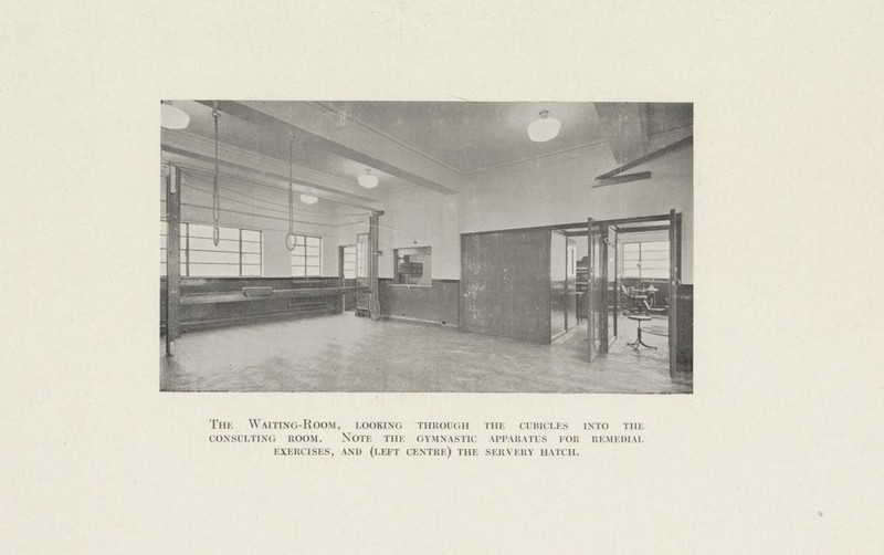 The Waiting-Room, looking through the cubicles into the consulting room. note the gymnastic apparatus for remedial exercises, and (left centre) the servery hatch.