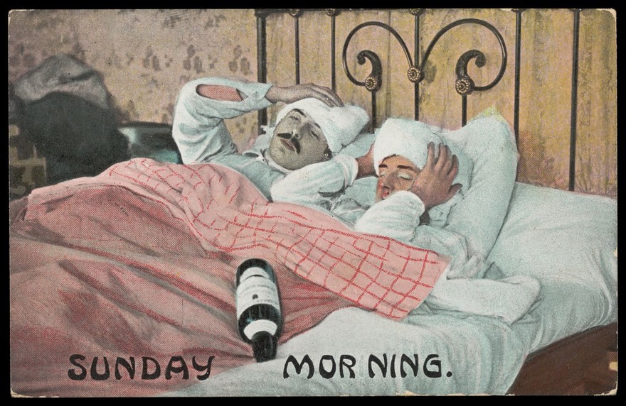 Two men in bed with a bottle on Sunday morning, holding their heads. Colour process print, ca. 1908.