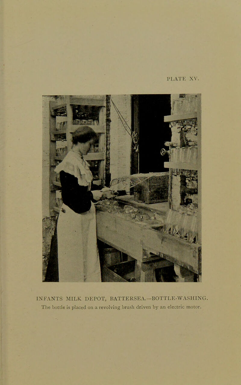 INFANTS MILK DEPOT, BATTERSEA.—BOTTLE-WASHING. The bottle is placed on a revolving brush driven by an electric motor.