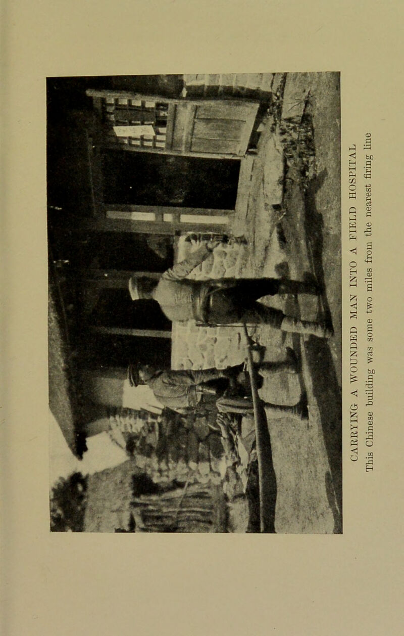 CARRYING A WOUNDED MAN INTO A FIELD HOSPITAL This Chinese building was some two miles from the nearest firing line