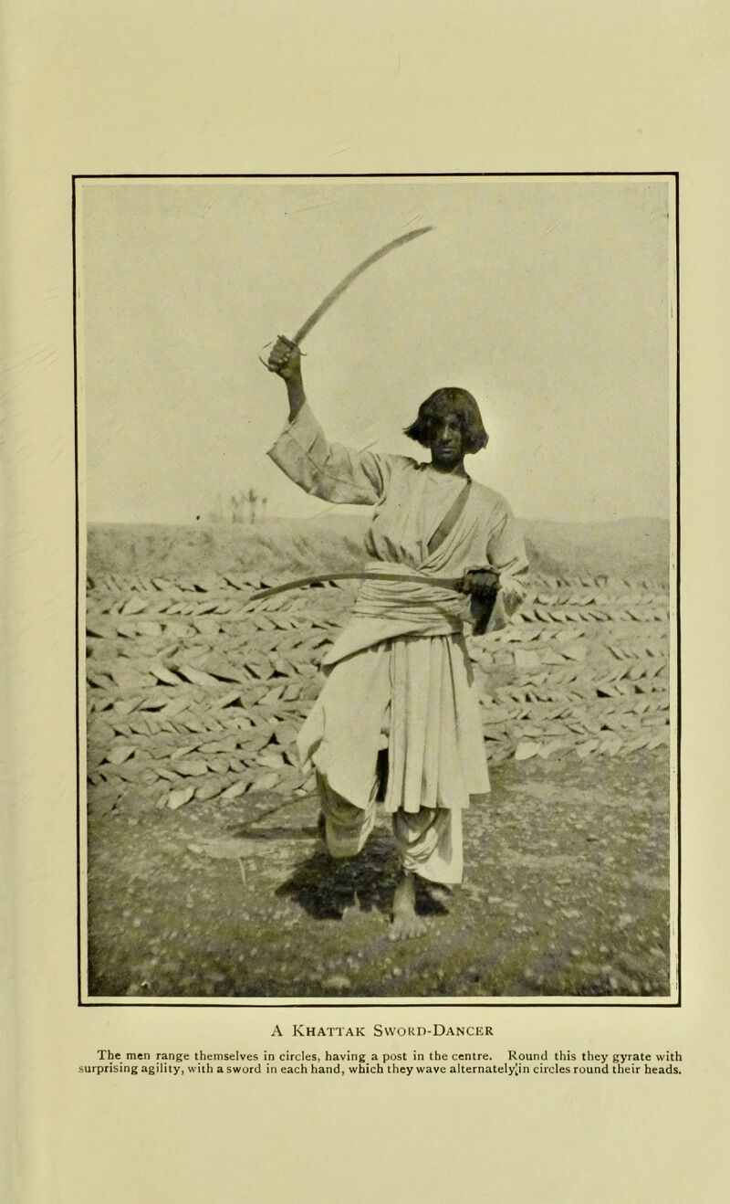 A Khattak Sword-Dancer The men range themselves in circles, having a post in the centre. Round this they gyrate with surprising agility, with a sword in each hand, which they wave alternately|in circles round their heads.