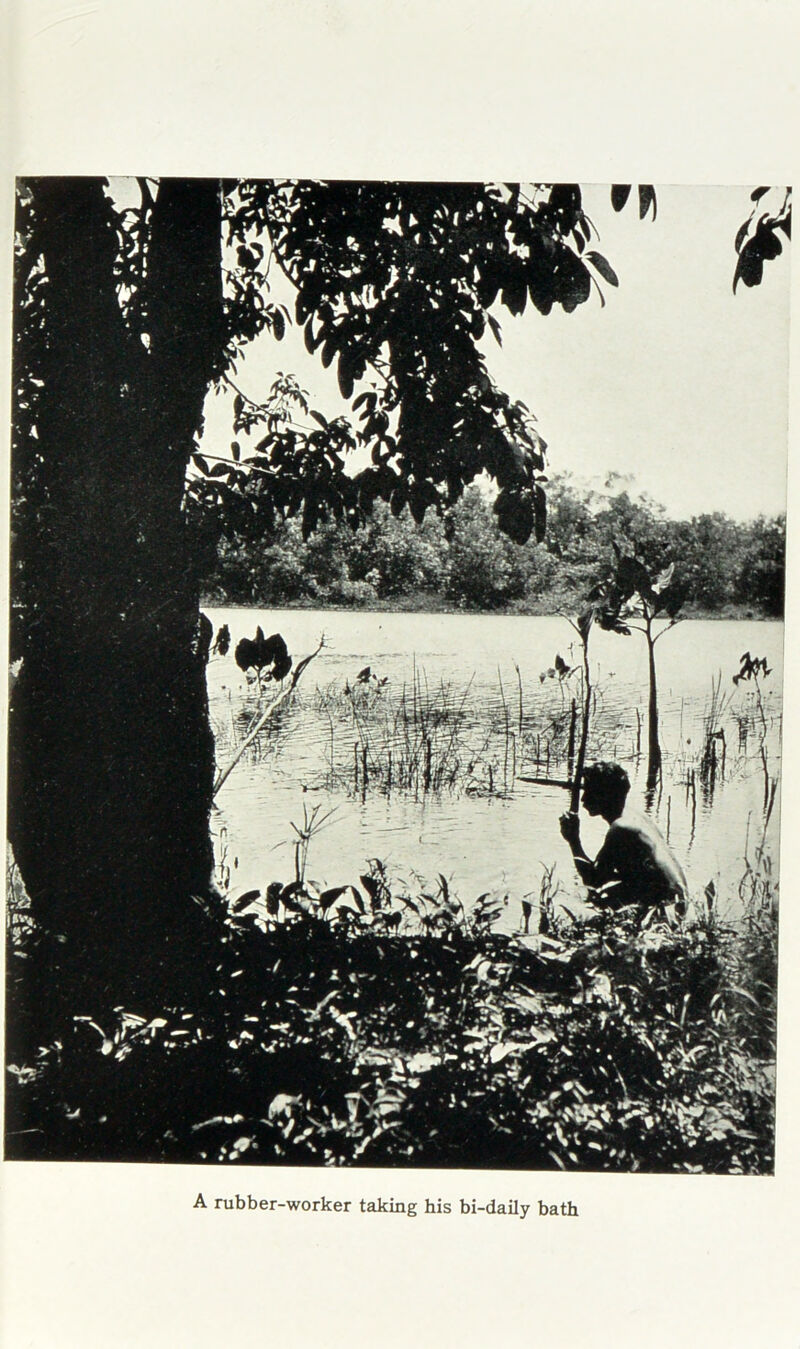 A rubber-worker taking his bi-daily bath