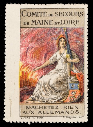 [French charity stamp showing a woman gestuting towards a burning town, a French tricolore flag in her right urging people to buy nothing from the Germans: "N'achetez rien aux Allemands"].