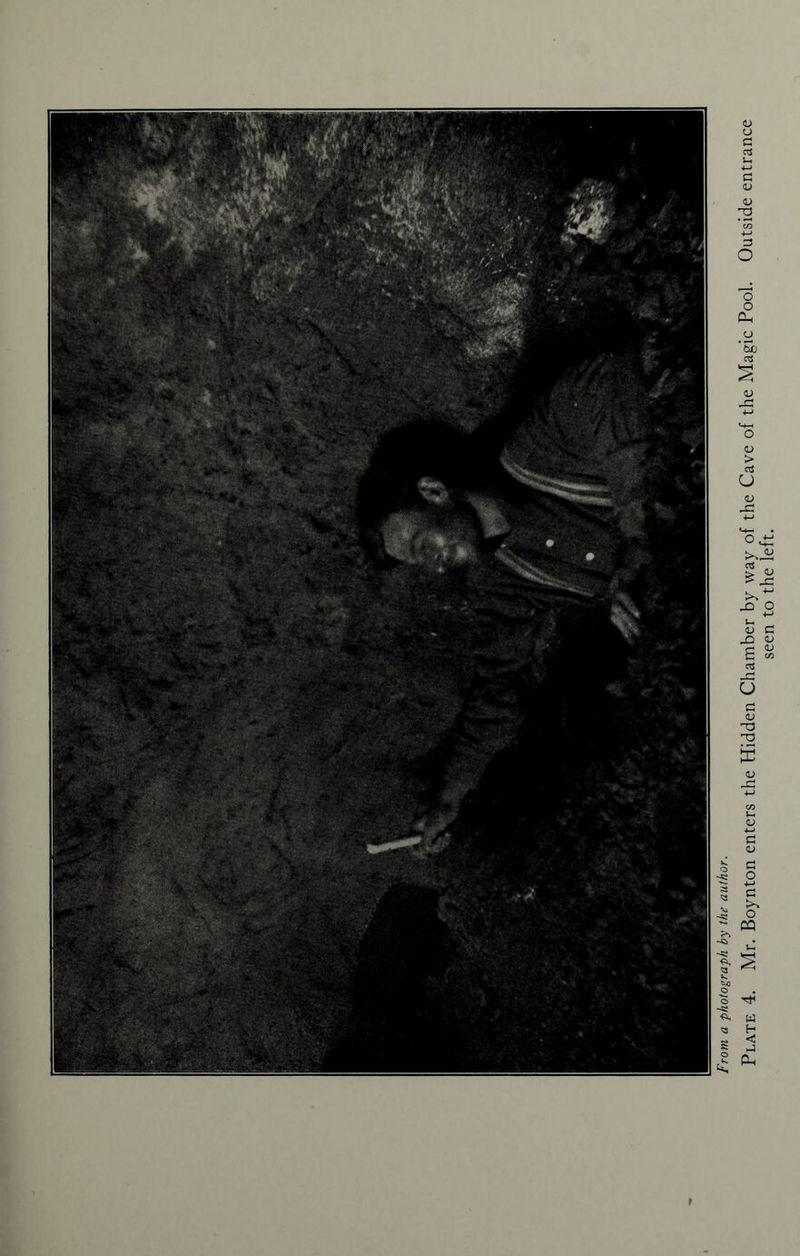 ► From a photograph by the author. Plate 4. Mr. Boynton enters the Hidden Chamber by way of the Cave of the Magic Pool. Outside entrance seen to the left.