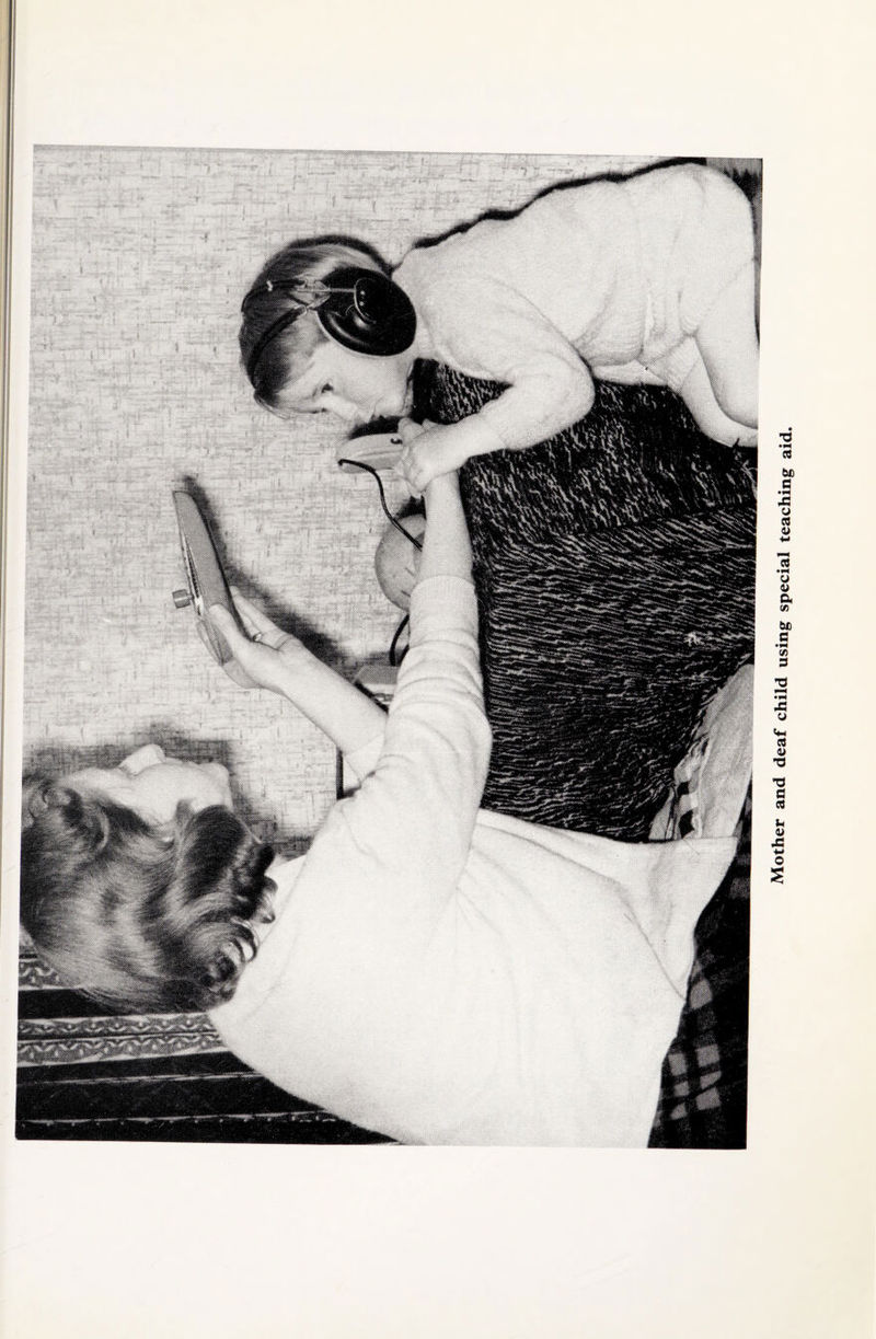 Mother and deaf child using special teaching aid.