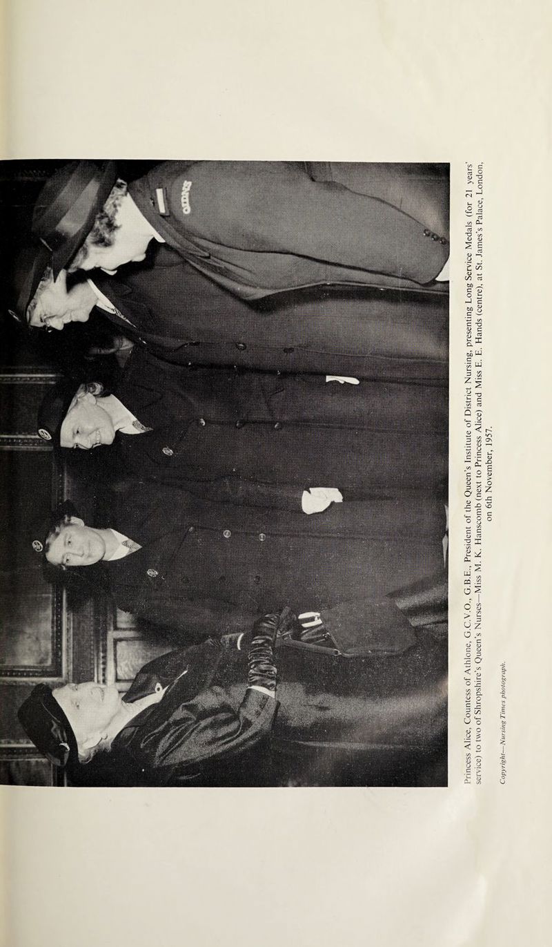 Princess Alice, Countess of Athlone, G.C.V.O., G.B.E., President of the Queen's Institute of District Nursing, presenting Long Service Medals (for 21 years' service) to two of Shropshire's Queen's Nurses—Miss M. K. Hanscomb (next to Princess Alice) and Miss E. E. Hands (centre), at St. James's Palace, London, on 6th November, 1957. Copyright—Nursing Times photograph.