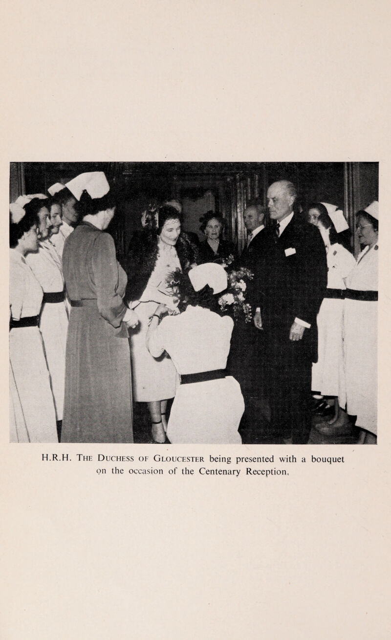 H.R.H. The Duchess of Gloucester being presented with a bouquet on the occasion of the Centenary Reception,