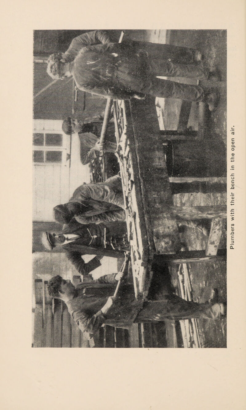 Plumbers with their bench in the open air.