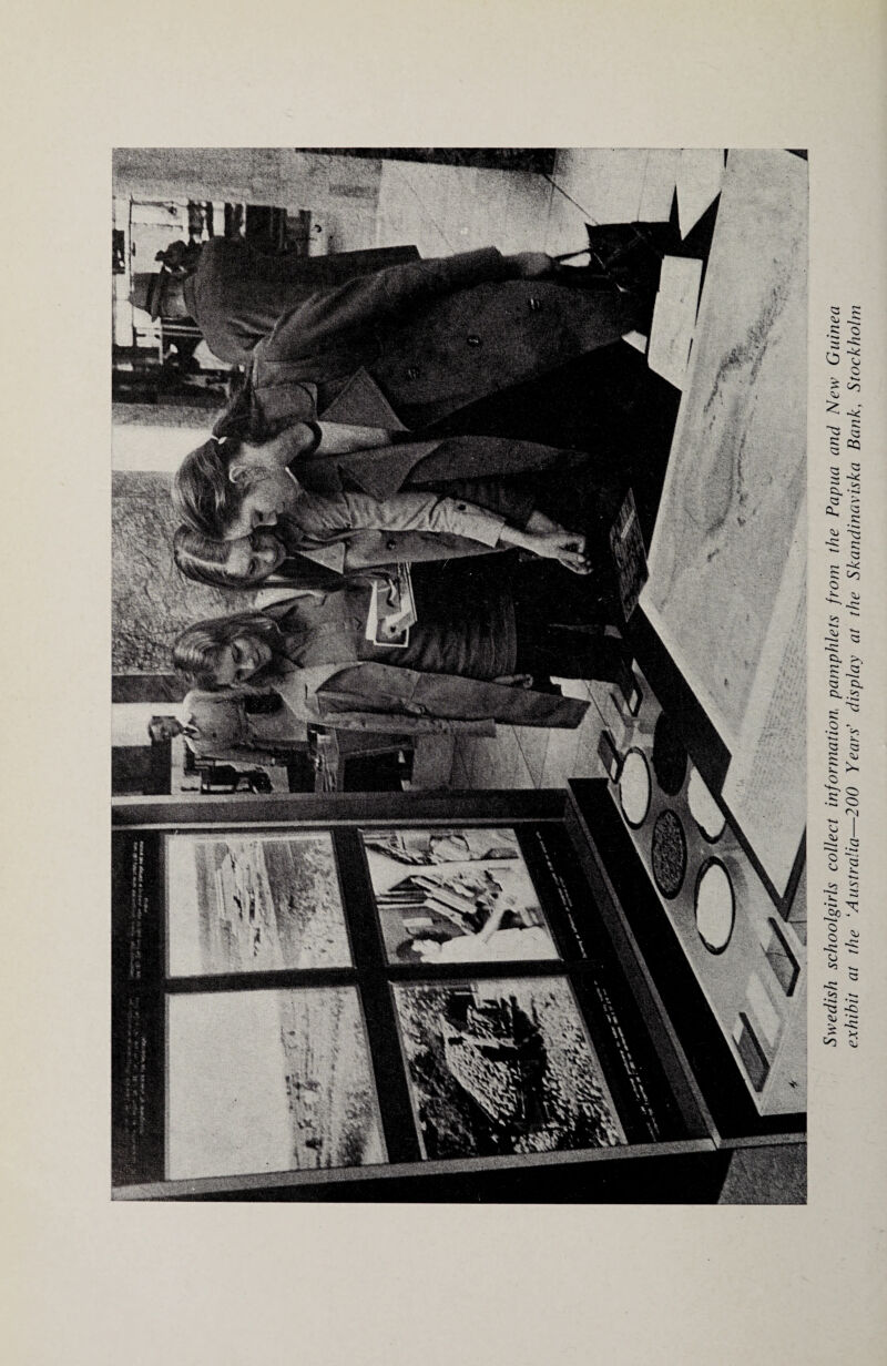 Swedish schoolgirls collect information pamphlets from the Papua and New Guinea exhibit at the ‘Australia—200 Years’ display at the Skandinaviska Bank, Stockholm