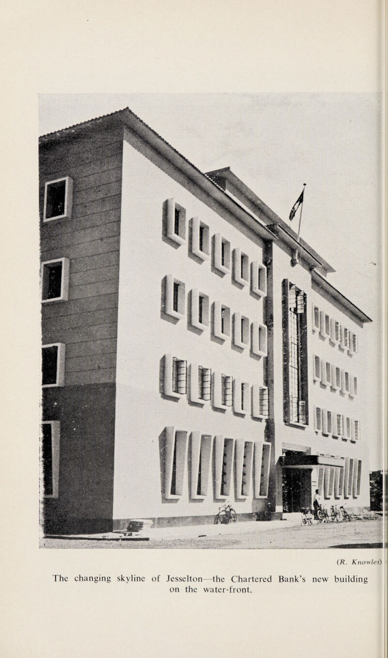 (R. Knowles) The changing skyline of Jesselton—the Chartered Bank’s new building on the water-front.