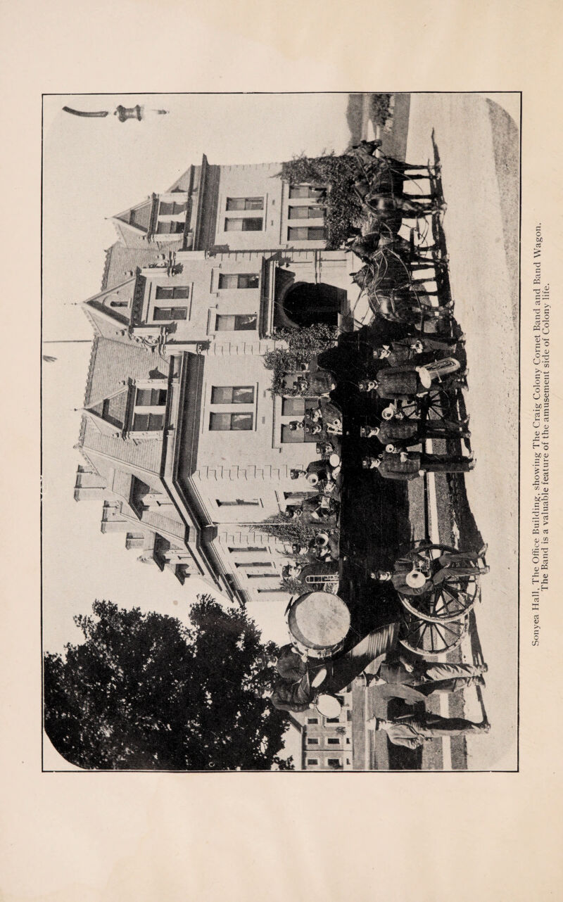 Soiiyea Hall, The Office Building;, showing The Craig Colony Cornet Band and Band Wagon. The Band is a valuable feature of the amusement side of Colony life.
