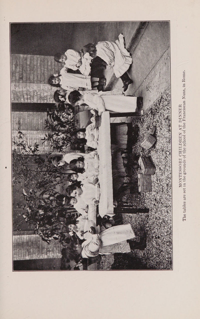ool of the Franciscan Nuns, in Rome. ds of the sch a MONTESSORI CHILDREN AT DINNER The tables are set in the grour