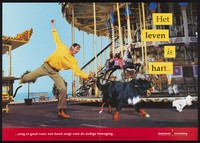 view A man at a funfair by the seaside, being compelled to move rapidly by his dog pulling him forwards; representing exercise as good for the heart. Colour lithograph for the Nederlandse Hartstichting, ca. 2000.