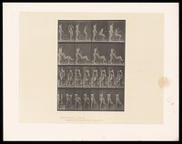 view A naked woman smoking a cigarette sits down in a chair and crosses her legs. Another naked woman stands behind the chair, her hands resting on the back of it. Collotype after Eadweard Muybridge, 1887.